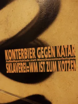 This sticker expresses protest against the 2022 FIFA World Cup in Qatar, criticizing the human rights abuses and worker exploitation associated with the event.  It promotes the idea of a 'Football Spartakiad' as an alternative.