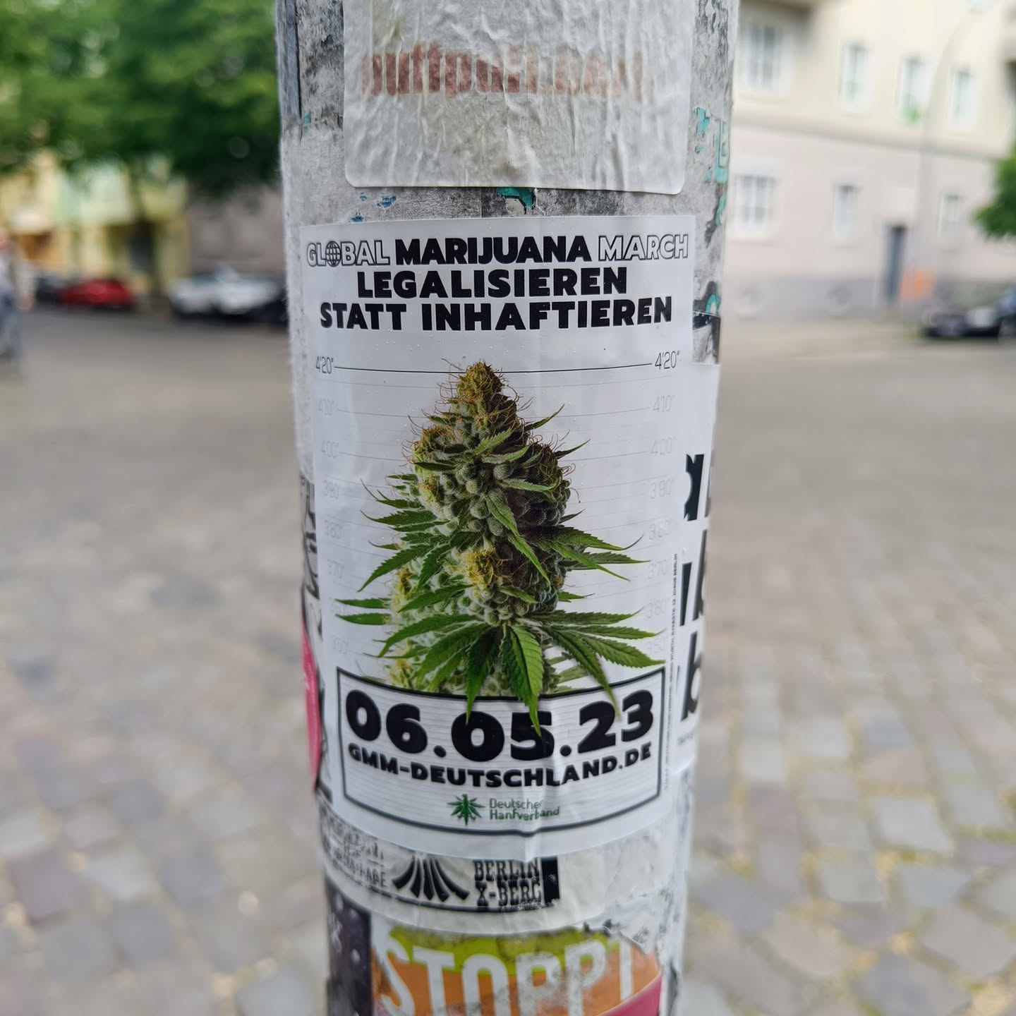 Sticker promoting the Global Marijuana March in Germany on June 5th, 2023.  It features an image of a marijuana plant and the website address for the event.
