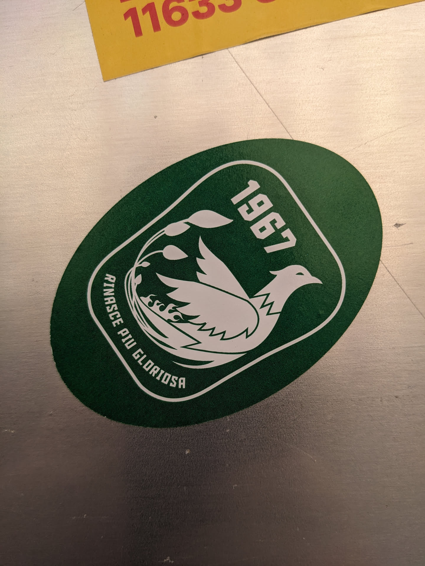 Green and white sticker featuring a bird design and the year 1967. The text "Rinasce Più Gloriosa" is visible.