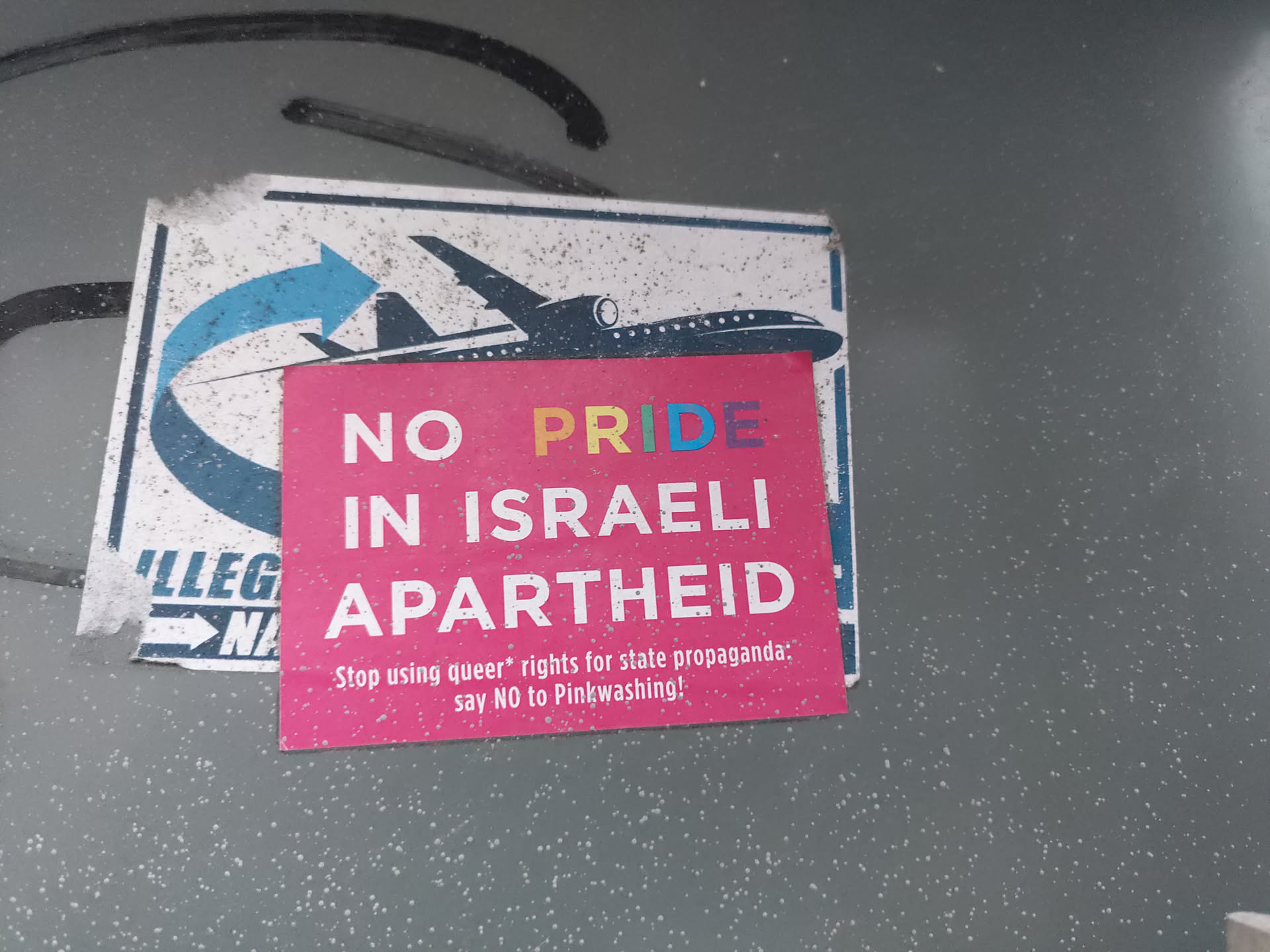 A sticker with a plane and text protesting the use of LGBTQ+ rights to promote Israeli policies.  The sticker advocates saying no to Pinkwashing.