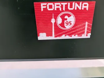 Red and white sticker with the Fortuna Dusseldorf logo and a city skyline. The number 95 is visible in the logo.