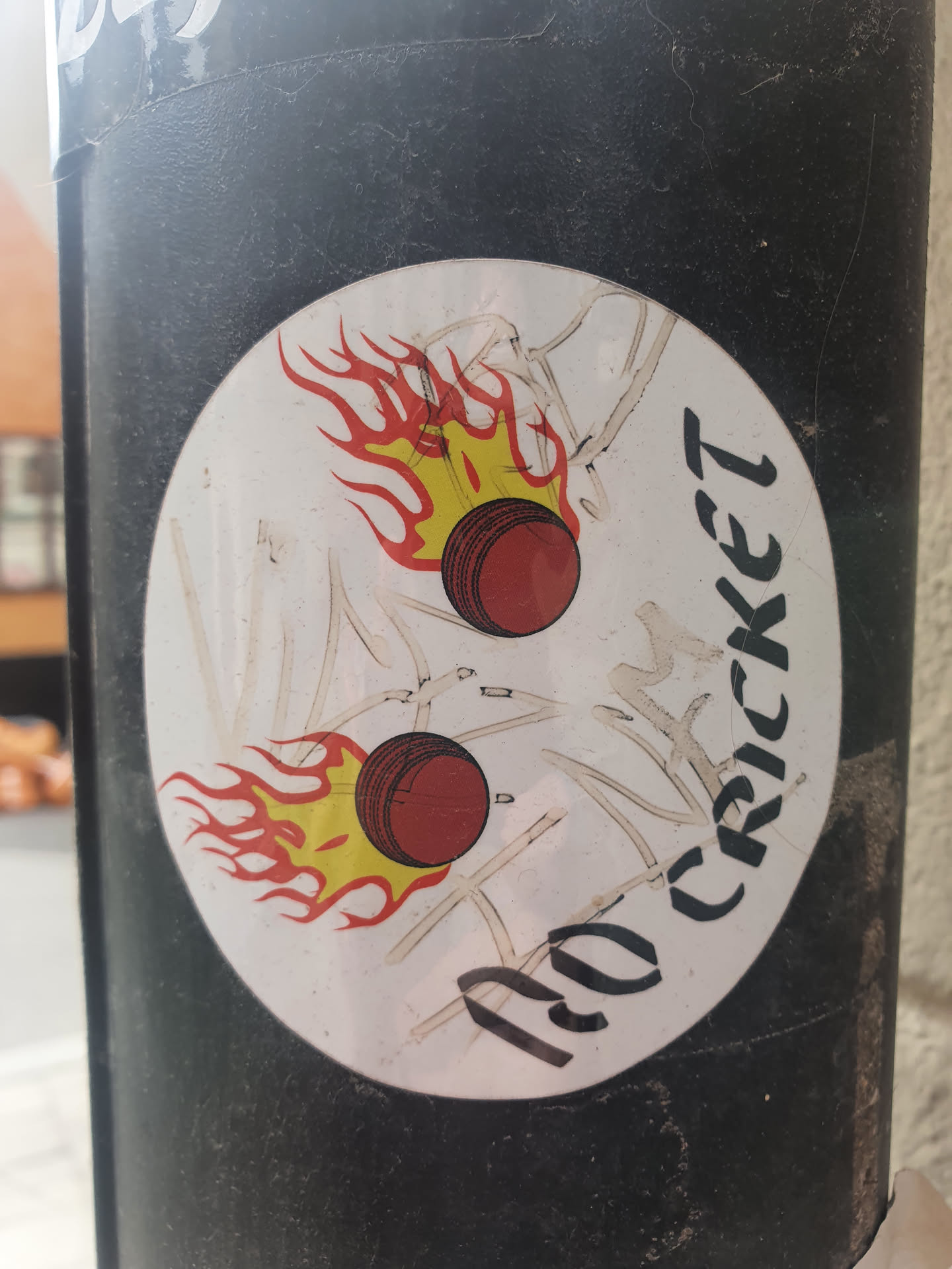 Round sticker featuring two cricket balls on fire. The text "No Cricket" is written in a stylized font.