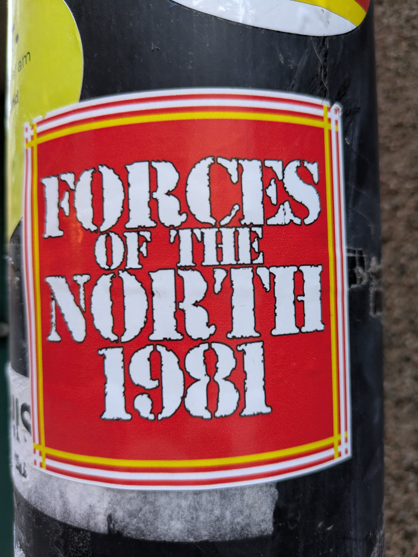 A red and yellow sticker with the text "Forces of the North 1981" in a bold, white, stencil-like font. The sticker has a simple, rectangular design with a thin yellow and white border.