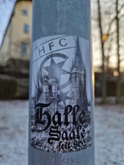Black and white sticker featuring a historical image of Halle Saale, Germany, with the text "Halle Saale" and "1880" underneath. There is also an HFC logo in the upper left corner, which could stand for a local sports club or organization.