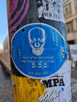 A blue round sticker with a bald head illustration and a text that says: "I have seen the future and there is no future". The sticker also contains a social media handle @sadgaydontcry. 