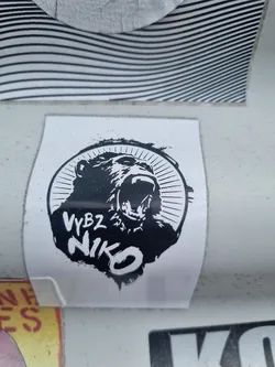 Black and white sticker featuring a roaring gorilla in a circular design. The name 'VyBZ NIKO' is written underneath the gorilla.