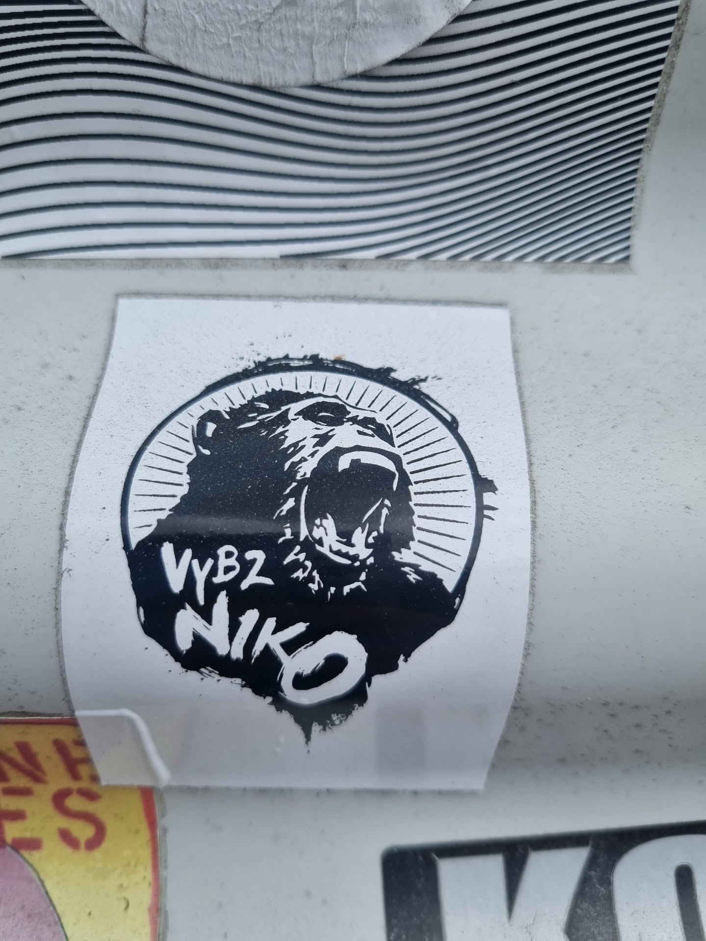 Black and white sticker featuring a roaring gorilla in a circular design. The name 'VyBZ NIKO' is written underneath the gorilla.
