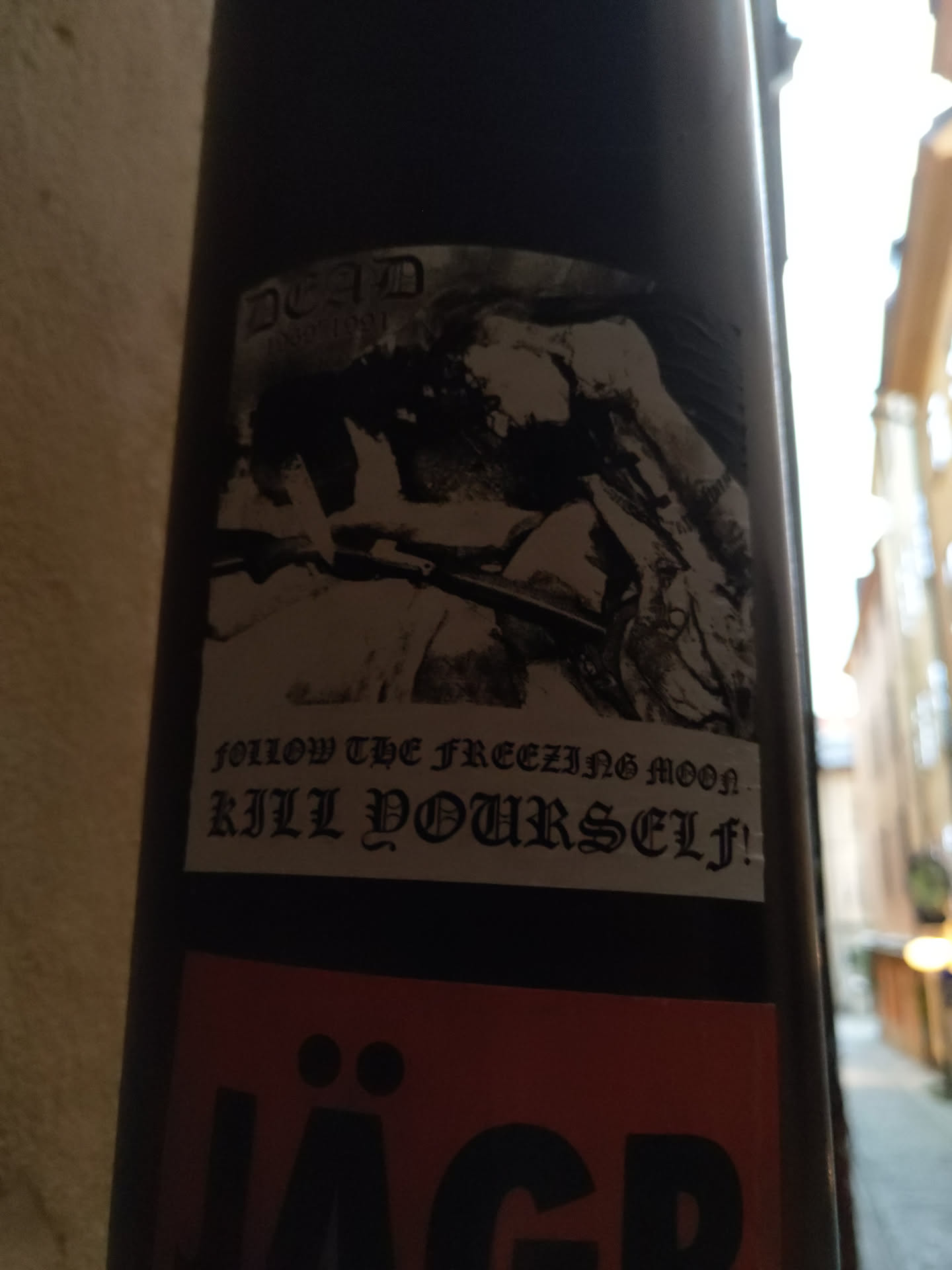 Black and white sticker with a graphic image and text. The text says  "Follow the freezing moon, kill yourself!"