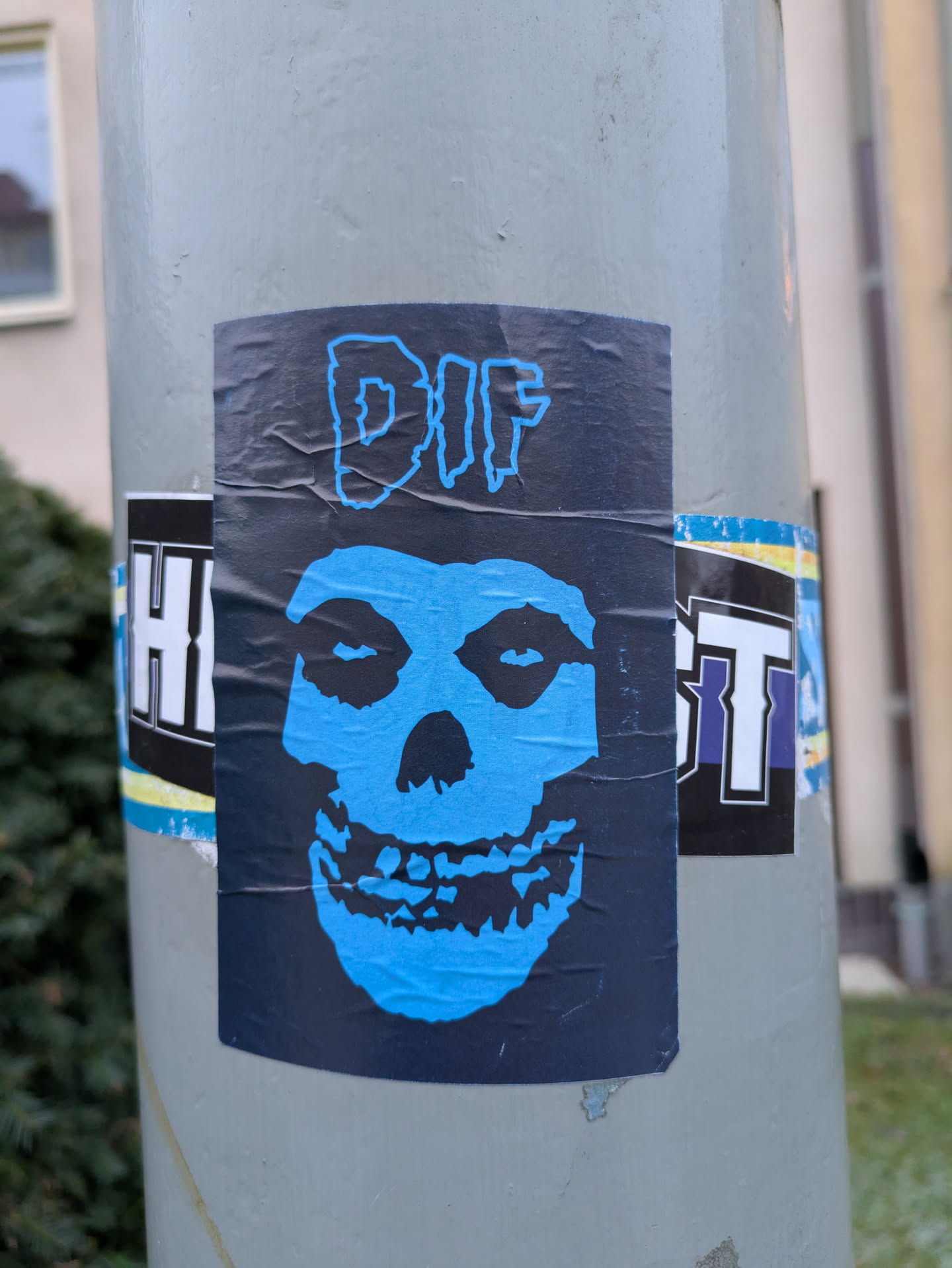 A sticker featuring a Misfits' iconic Fiend skull in light blue on a dark background.  The text "DIF" is at the top of the sticker.