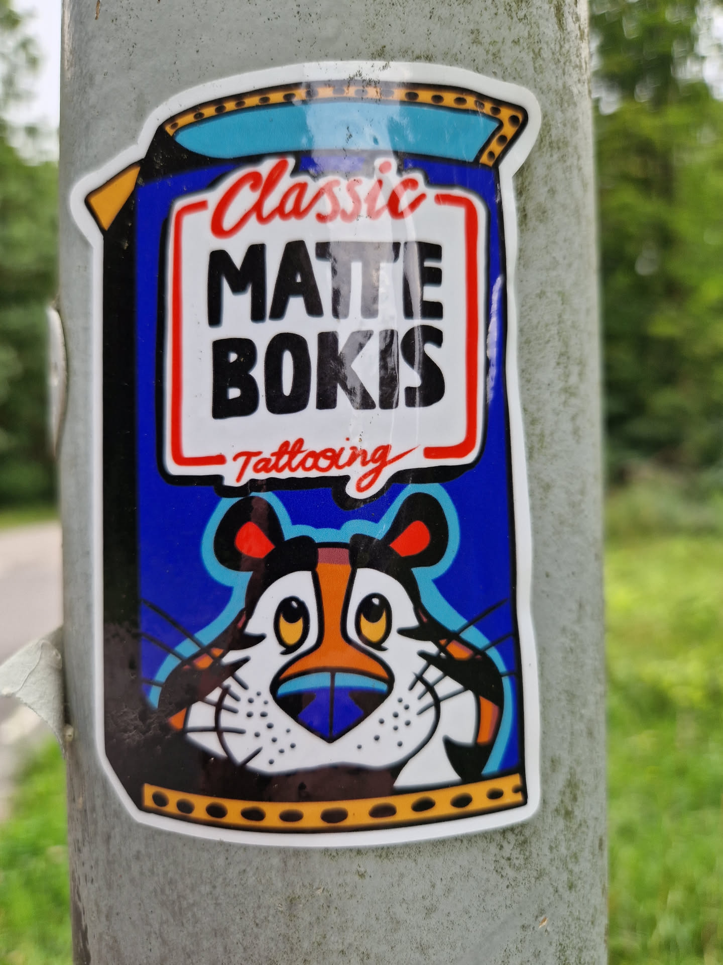 A sticker featuring Tony the Tiger from Frosted Flakes, reimagined with a tattooing theme. The text 'Classic Matte Bokis Tattooing' is prominently displayed.