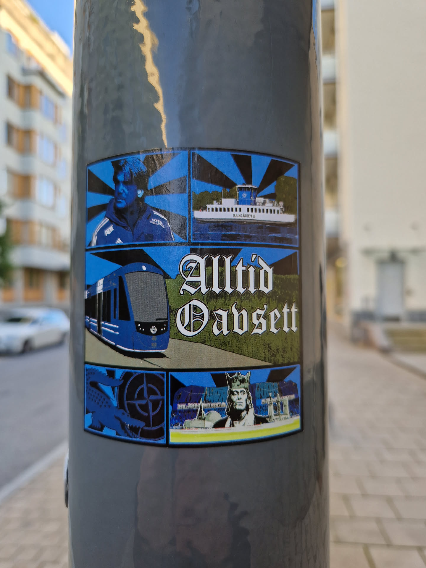 A sticker featuring a collage of images related to public transport in Sweden, including a tram, ferry, and a portrait of what seems to be a person related to the public transport system or a sports figure. The style is reminiscent of vintage posters with a color palette of blues and blacks. The text 'Alltid Oavsett' translates from Swedish to 'Always Regardless'.