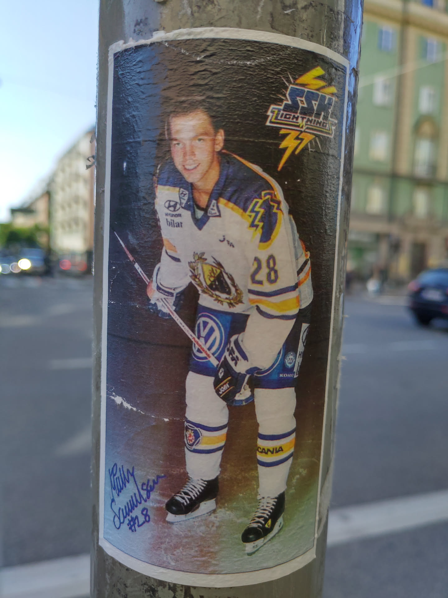 This sticker shows a photo of Ricky Sallinen, a hockey player, wearing a jersey with the number 28.  The team logo is visible as well as sponsors like Volkswagen and Hyundai. It has an autograph in the lower left corner.