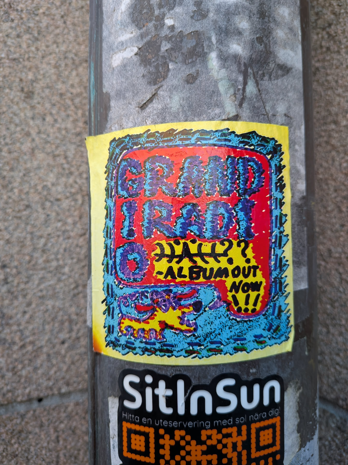 A rectangular sticker with a yellow border containing an inner textured frame in blue and black. Inside, a bold red background features chunky, stippled purple and blue lettering reading 'GRAND IRADIO'. Below the main title is handwritten text stating 'HALL??' alongside '-ALBUM OUT NOW!!!'. The bottom section depicts a stylized, colorful creature in yellow, purple, and red set against a blue speckled background.