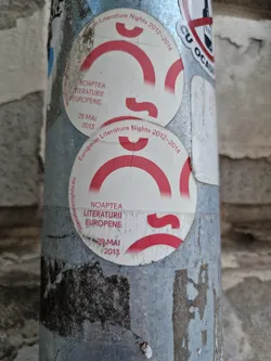 A worn sticker from the European Literature Nights event in 2013.  The sticker features a red logo and the dates of the event.