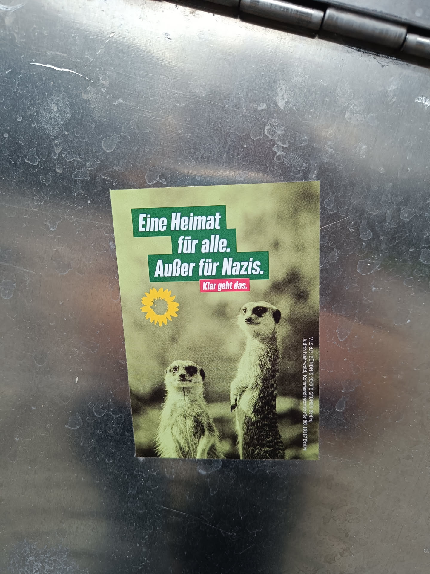 A sticker featuring two meerkats and a message in German that translates to 'A home for everyone. Except for Nazis. It's clear that it works.'
