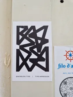 A black and white sticker featuring an abstract geometric design. The text '@moreless.type | TYPE IMPRESSION' is visible at the bottom. 