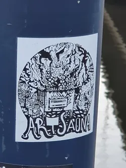 Black and white illustration sticker with the text "Art Sauna" at the bottom. The illustration contains abstract shapes and patterns, resembling a stylized sauna scene.