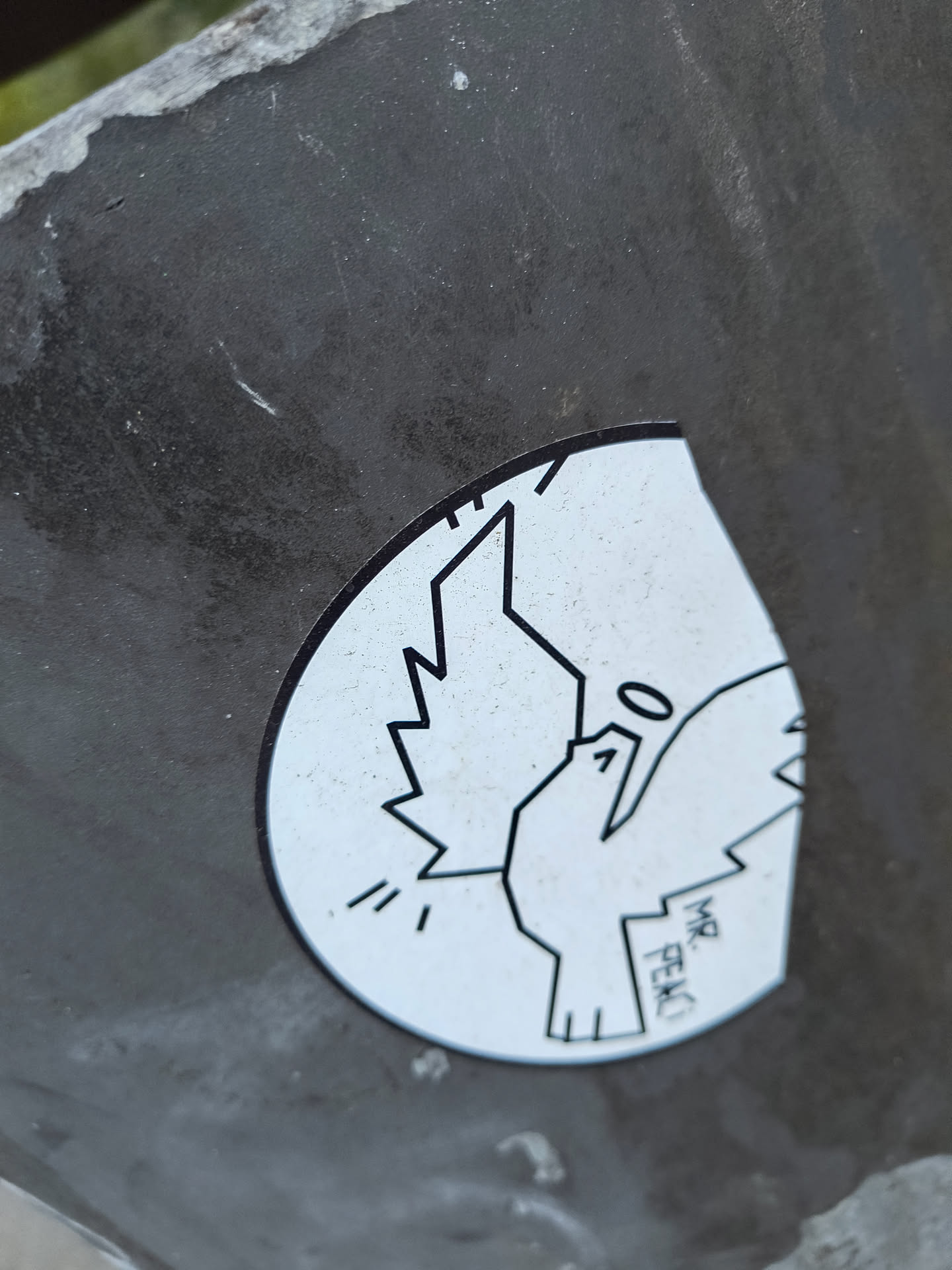 The sticker is circular with a white background and a black outline. It features a stylized depiction of a dove in flight. The dove has sharp, angular wings and a simple body. Above its head is a small circle, representing a halo. To the right of the dove's body, the text 'MR. PEAC' is written vertically in black, blocky letters. There are also three short, parallel lines emanating from the dove's chest, suggesting movement or sound.