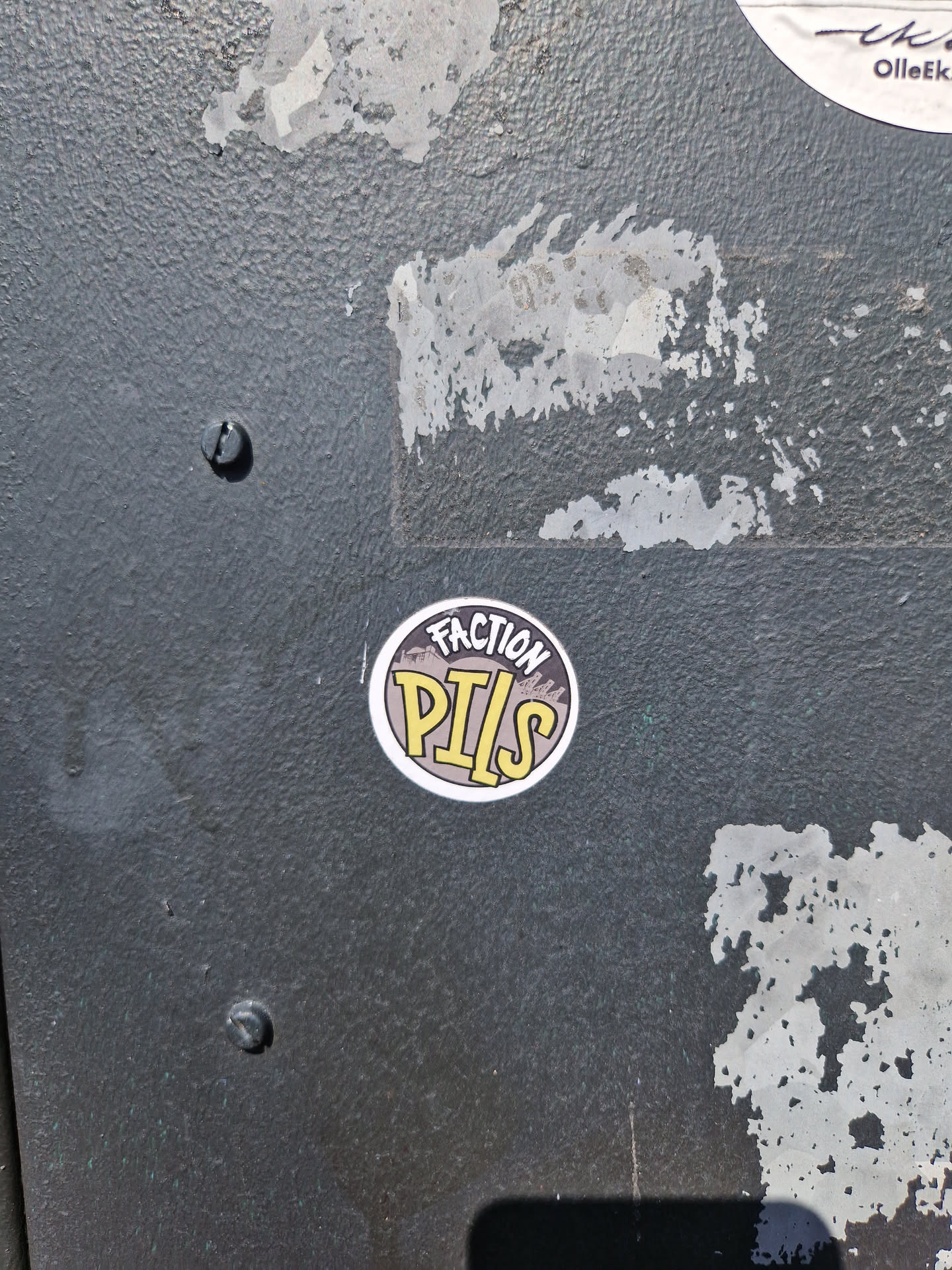 Round sticker with the text \"Faction Pills\" in yellow on a dark background with a mountain graphic. 
