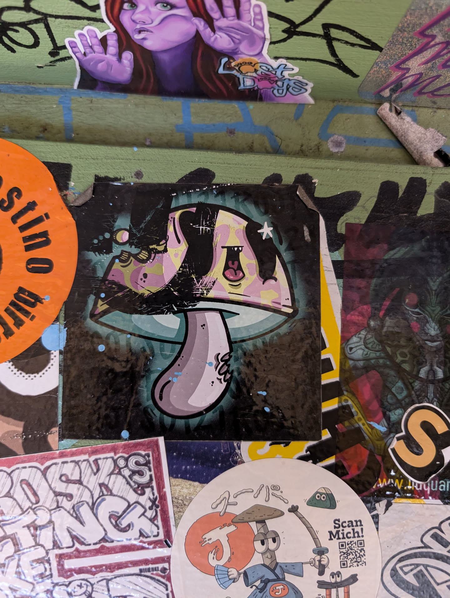 Funky, trippy sticker of a mushroom with a teal and pink color scheme. The style is reminiscent of graffiti art, with bold outlines and a slightly distressed look. The mushroom has a happy, almost cartoonish expression.