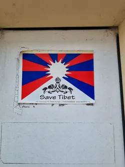 A sticker featuring the Tibetan flag and the words 'Save Tibet'.  The sticker also includes a website address.