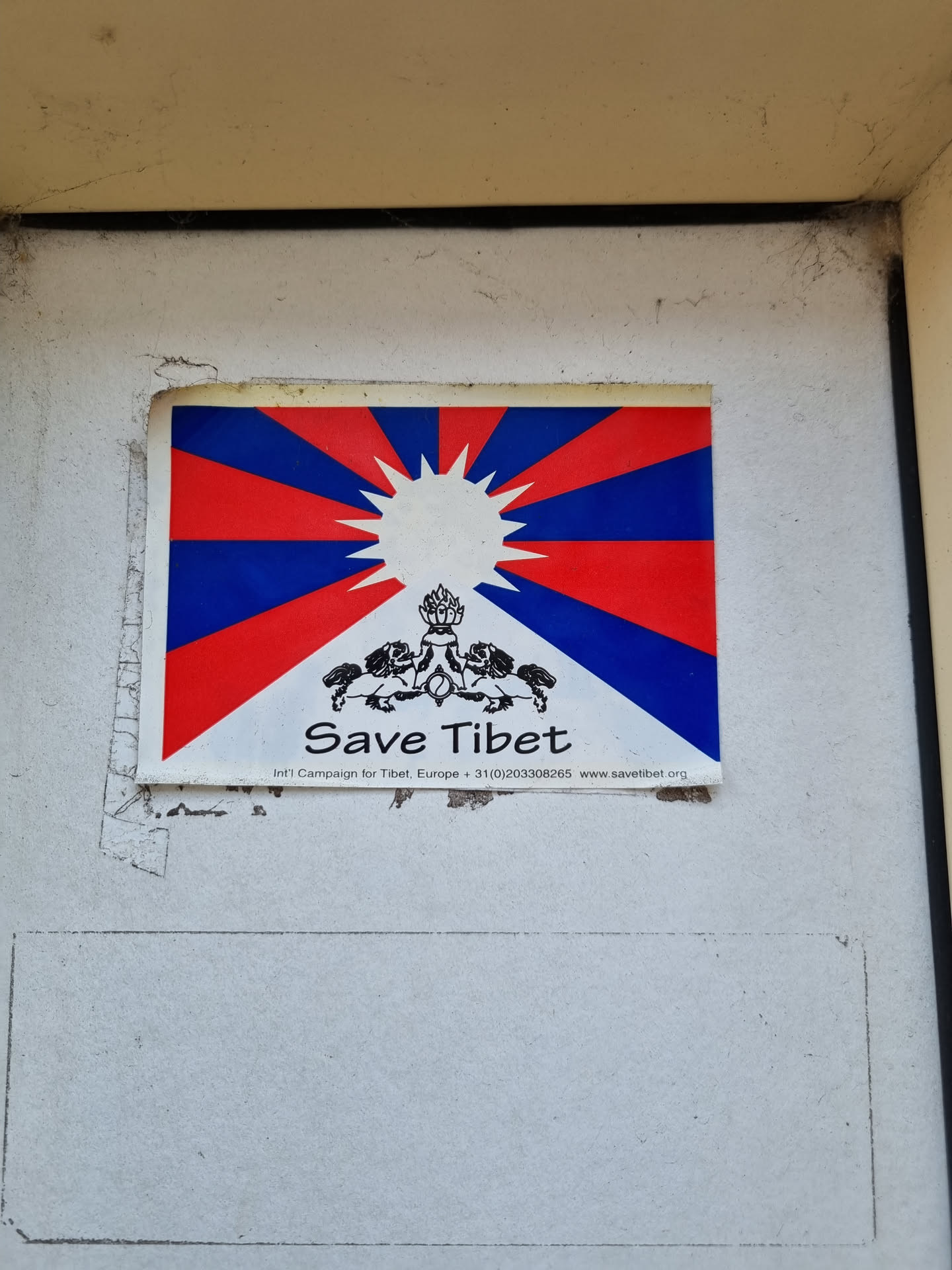 A sticker featuring the Tibetan flag and the words 'Save Tibet'.  The sticker also includes a website address.