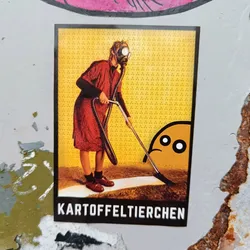 A sticker depicting a person wearing a gas mask and using a vacuum cleaner to clean up after a small, sad-looking character. The text at the bottom of the sticker says "Kartoffeltierchen."