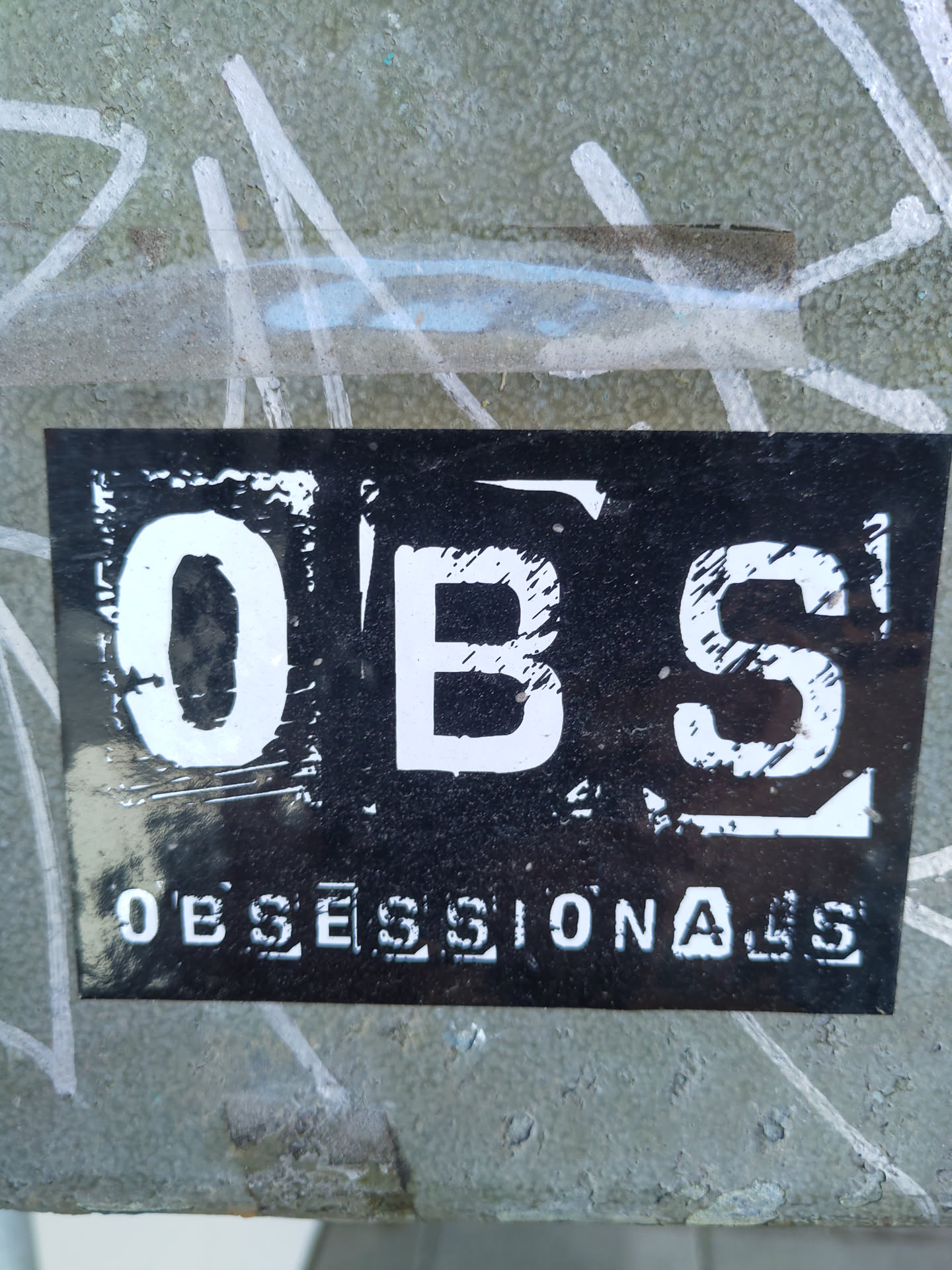 Black and white sticker with the word OBSESSIONALS. The word OBS is in a larger, bolder font.