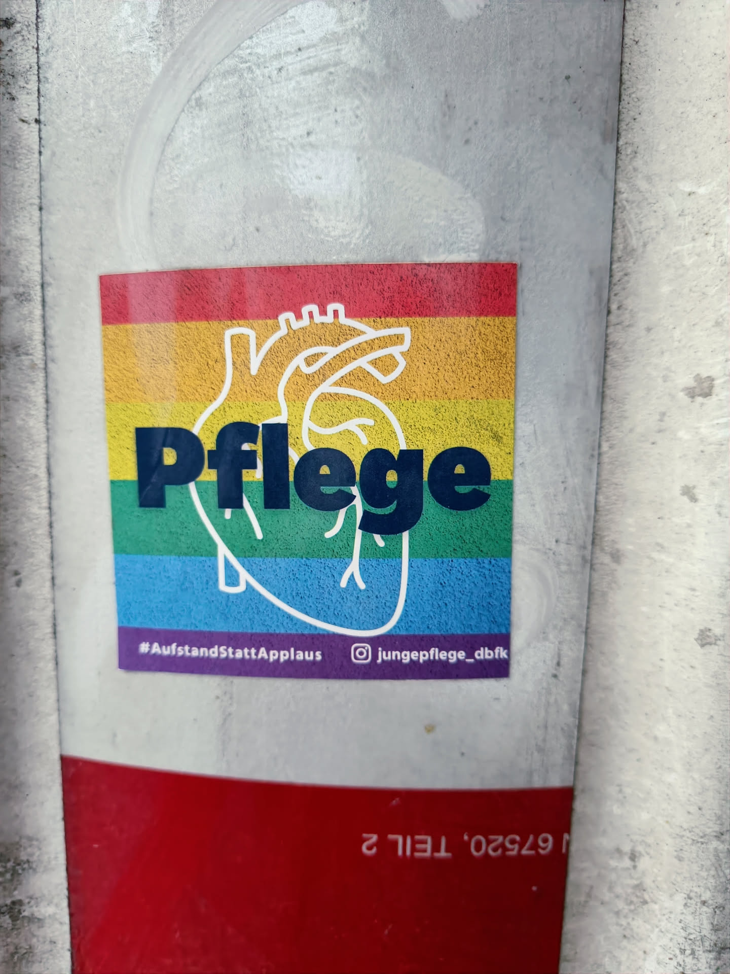 A rainbow-colored heart with the word "Pflege" (German for "care") in the center.  The sticker promotes the hashtag #AufstandStattApplaus and includes an Instagram link to @jungePflege_dbfk. 