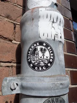 The sticker features a black and white design with the text "CULCANNA BILBAO" in a circular pattern around an image of a building, a bridge over water, palm trees, and two horses. The text "C.S.C." is at the bottom.