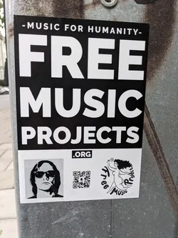 Sticker promoting Free Music Projects, an organization dedicated to providing free music. The sticker features a QR code, a black and white portrait, and an illustration of a woman. The main text on the sticker states "Free Music Projects.org".