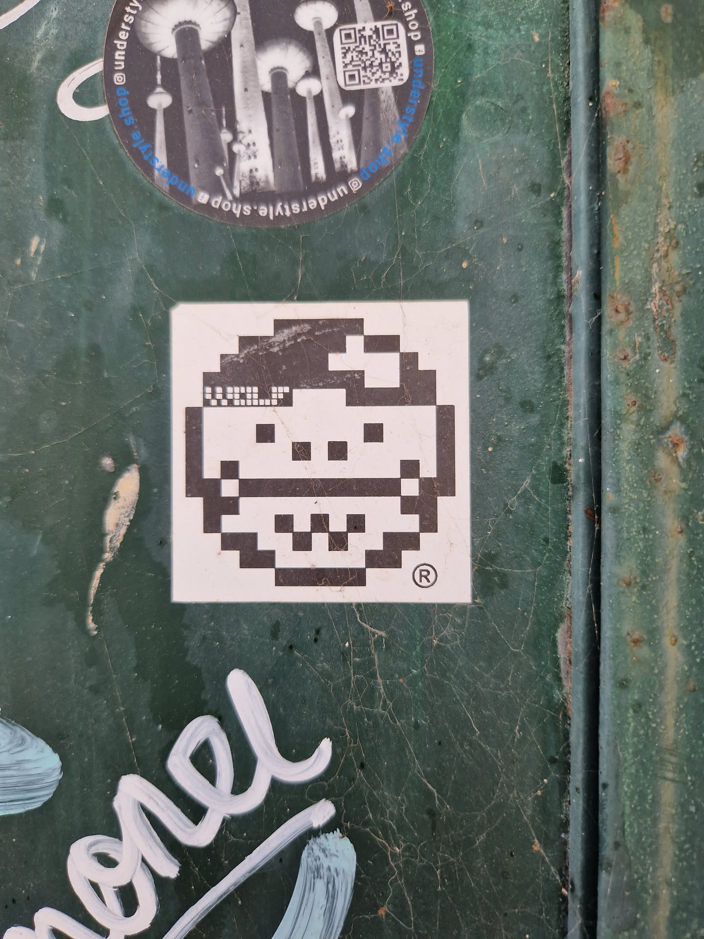 A small square sticker with a pixel art face. The face is simple and has a happy expression. The sticker is white with black pixels. There is a copyright symbol in the bottom right corner.