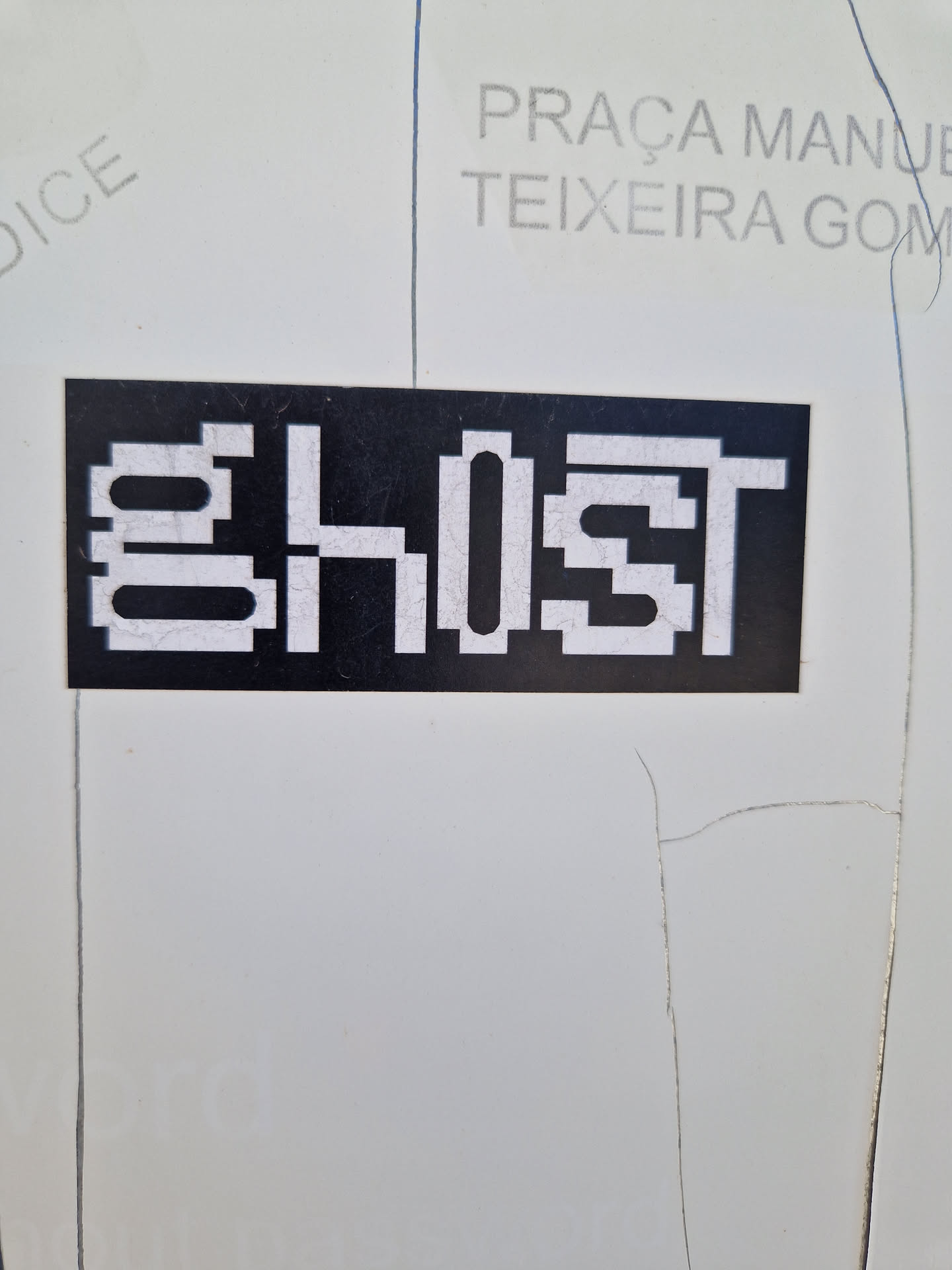 A black and white pixel art sticker with the word ghost on it.