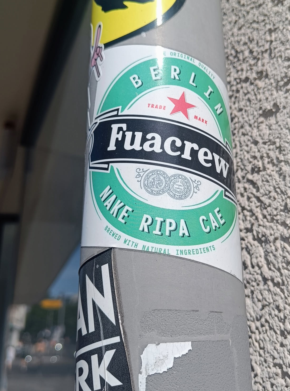 A sticker featuring a design reminiscent of a beer label.  The text reads 'Fuacrew Nake Ripa Cae' and includes 'Berlin' and mentions that it's brewed with natural ingredients.
