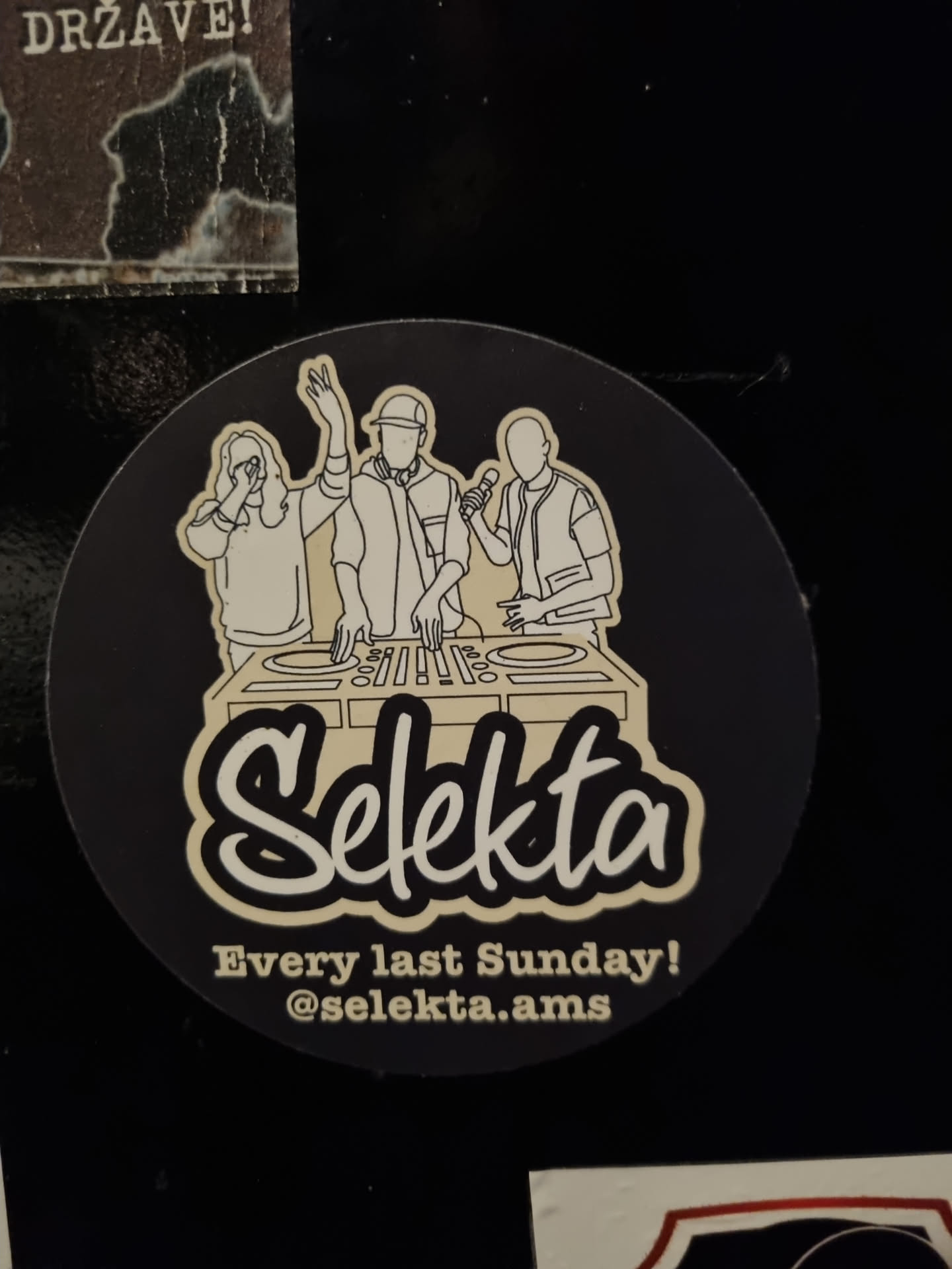 Round sticker with illustration of three people behind the decks.  The text 'Selekta' is prominently displayed, along with the tagline 'Every last Sunday!' and an Instagram handle.