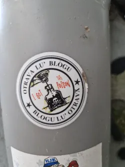 Round sticker with a skull and crossbones on a poison bottle. The text says Blogu Lu' Otrava and I got the poison in a circular design.