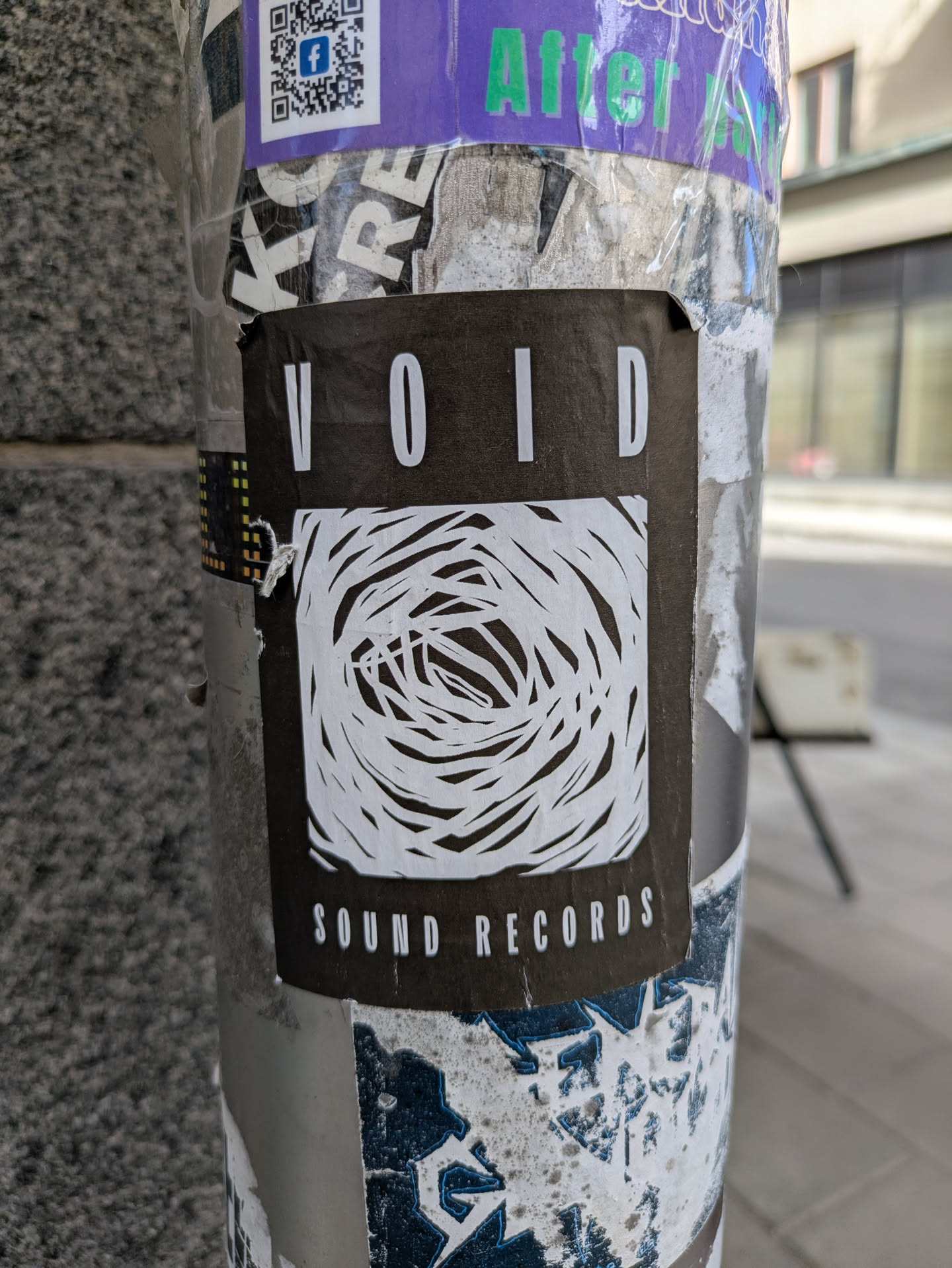 The sticker is a black rectangle with the word "VOID" at the top and "SOUND RECORDS" at the bottom, both in white capital letters. In the center is a white, abstract drawing that resembles a vortex or a maze of intertwined lines.