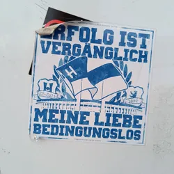 A blue and white sticker with a logo and text in German.  The logo features a stylized flag and the years 1892 and 25.07.1?. The text translates to "Success is fleeting. My love unconditional."