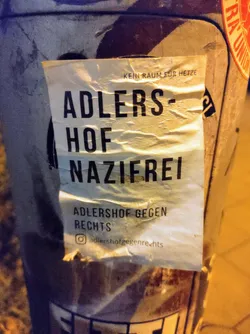 Sticker promoting Adlershof against the right. It says Adlershof Nazifrei (Adlershof Nazi-free) and Kein Raum für Hetze (No room for incitement).  There is an Instagram handle at the bottom.