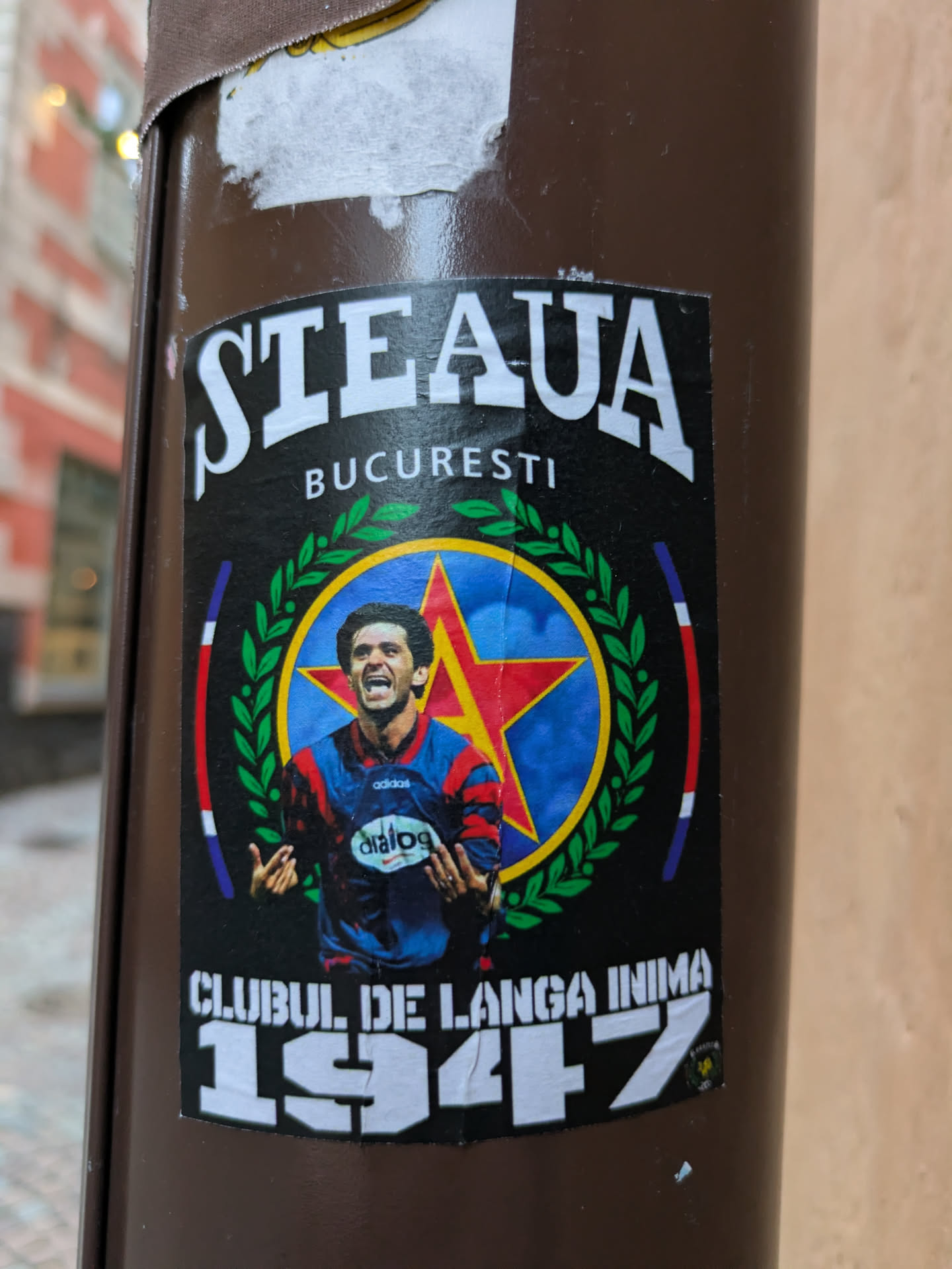A sticker depicting a football player from Steaua Bucuresti, a Romanian football club, with the club's logo and the year 1947. The text "Steaua Bucuresti" and "Clubul de langa inima 1947" is visible on the sticker.