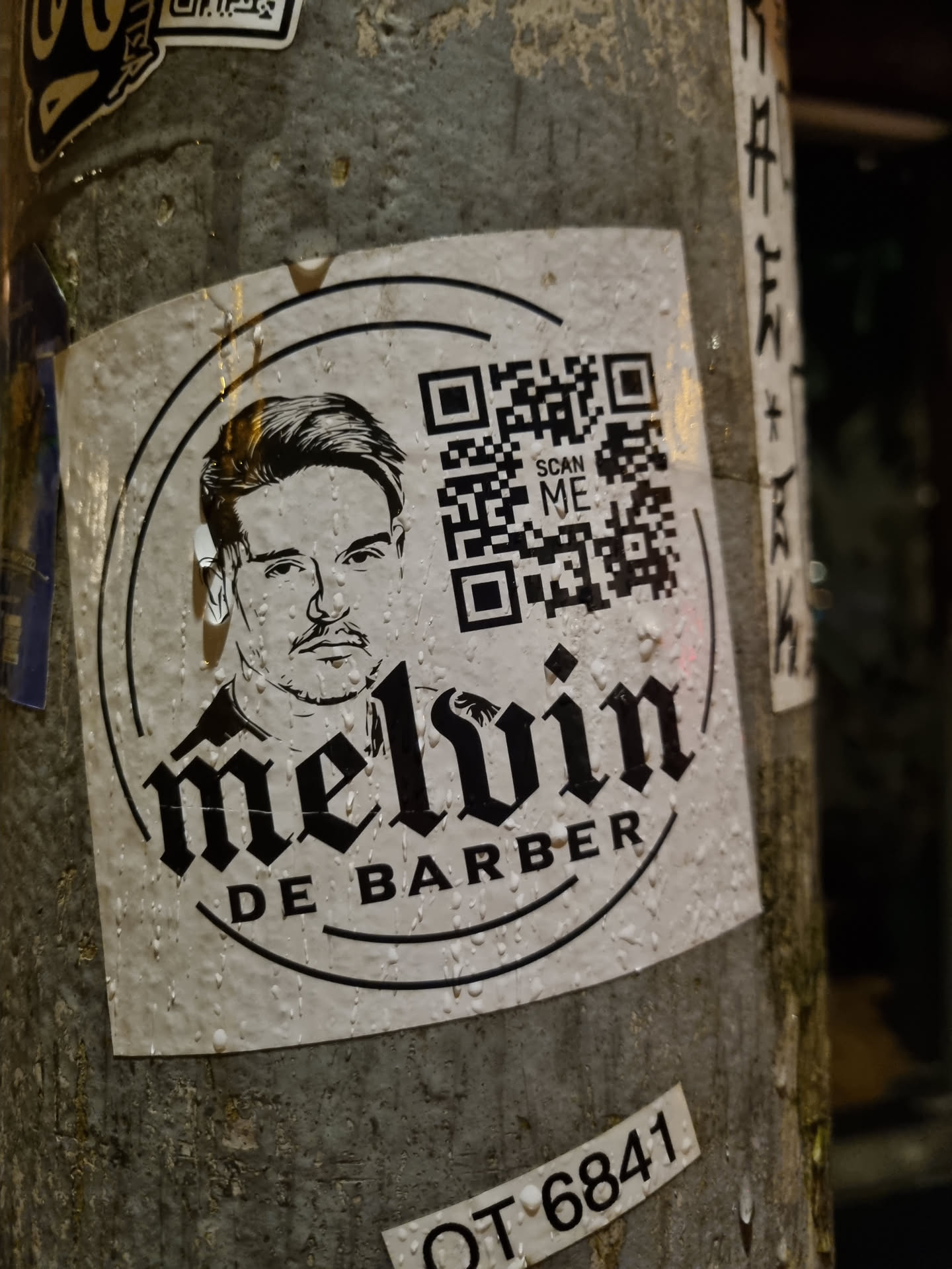 A sticker featuring a portrait of Melvin De Barber and a QR code. The design is in black and white with a circular border.