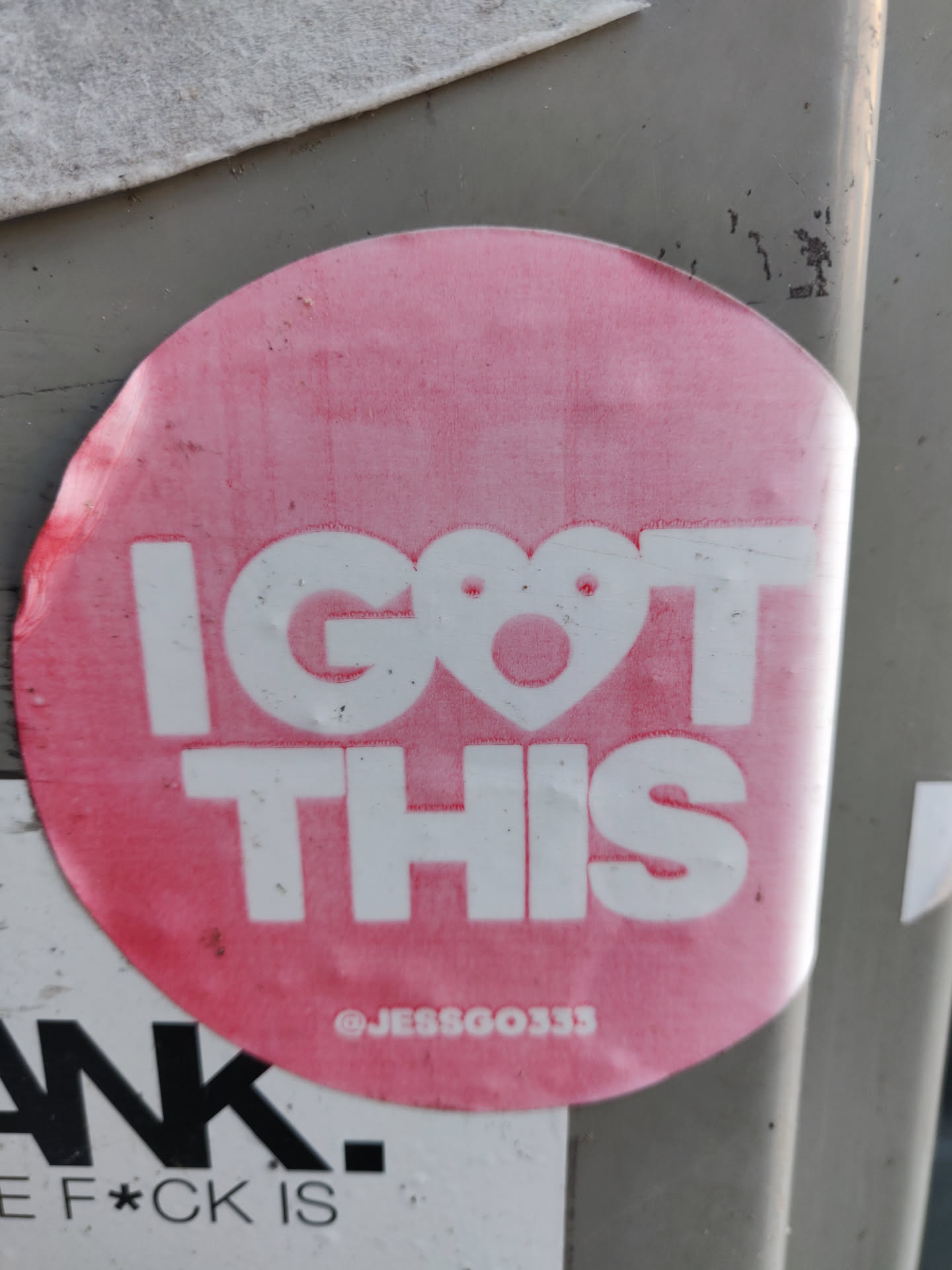 Pink round sticker with the text "I GOT THIS" in bold white uppercase letters. A small heart is in place of the letter "O". The text "@JESSGOO333" is visible at the bottom of the sticker. 