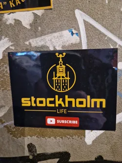 Black and gold sticker with an illustration of a building and the text "Stockholm - LIFE - Subscribe".  There is a Youtube subscribe button.