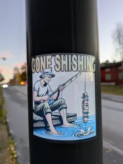 A sticker depicting a man fishing, but instead of a fish, he's catching a shish kebab. The text 'Gone Shishing' is at the top.