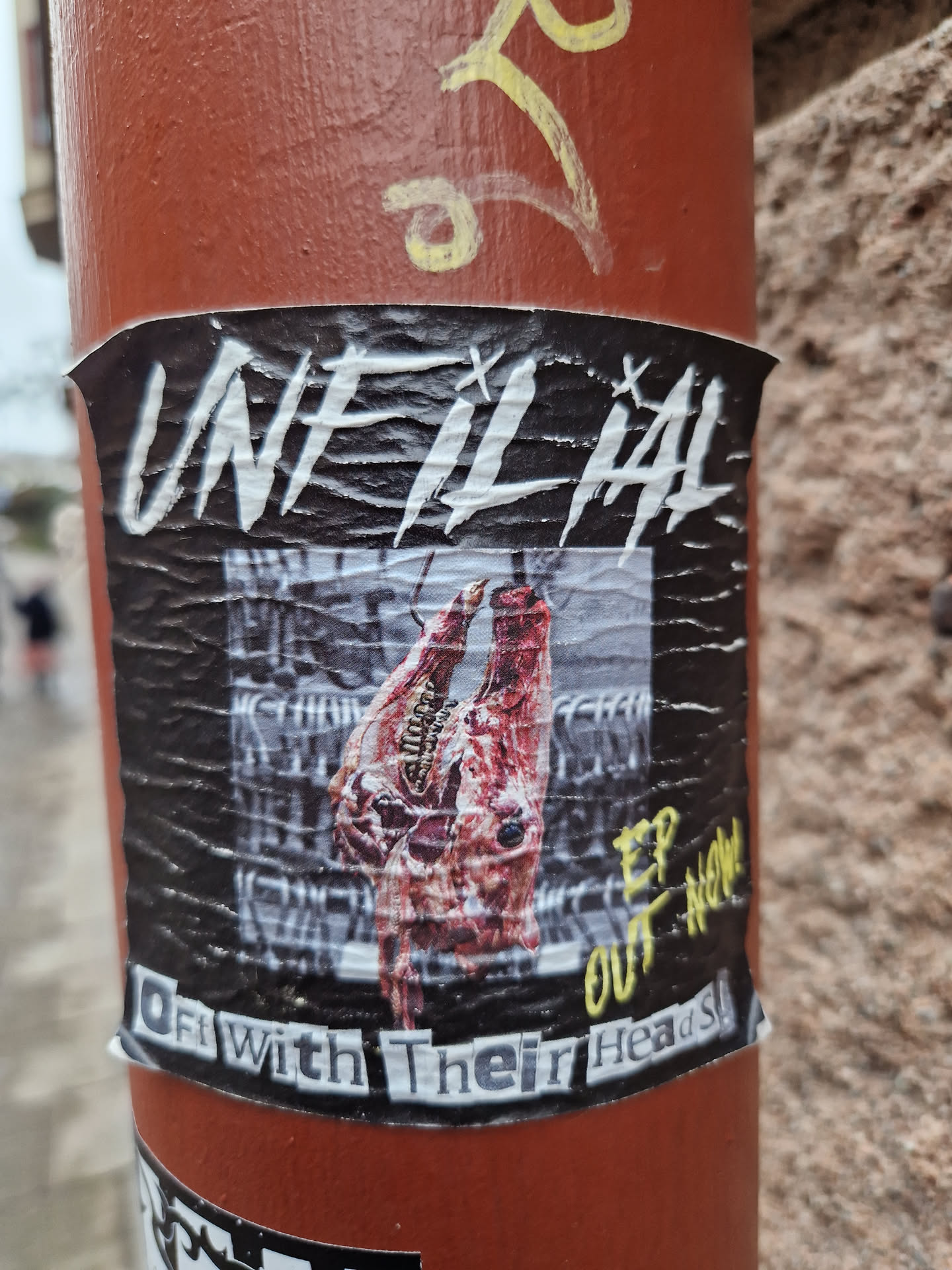 Sticker featuring artwork of two severed animal heads. Text on the sticker reads "UnfilthAl" in large letters, and "Off With Their Heads" at the bottom.  There's also "EP OUT NOW" written in a different font.