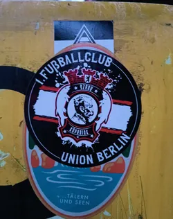 A black and white circular sticker featuring the logo of 1. FC Union Berlin. The logo includes the club's name, a coat of arms, and the words "Köpenick" and "UNION BERLIN".