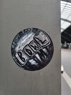 Street sticker Round black and white sticker with the band's name Biowül and the words "Biowül Band" written around it. It features a stylized illustration that looks like a record or a similar object.