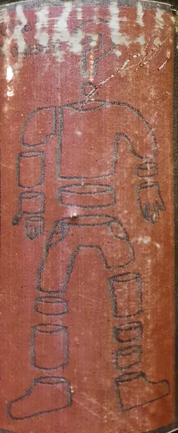 Reddish-brown sticker depicting a robot figure disassembled into segments. The style is minimalistic and somewhat crude. The robot appears humanoid, with separate pieces for the head, torso, arms, and legs.