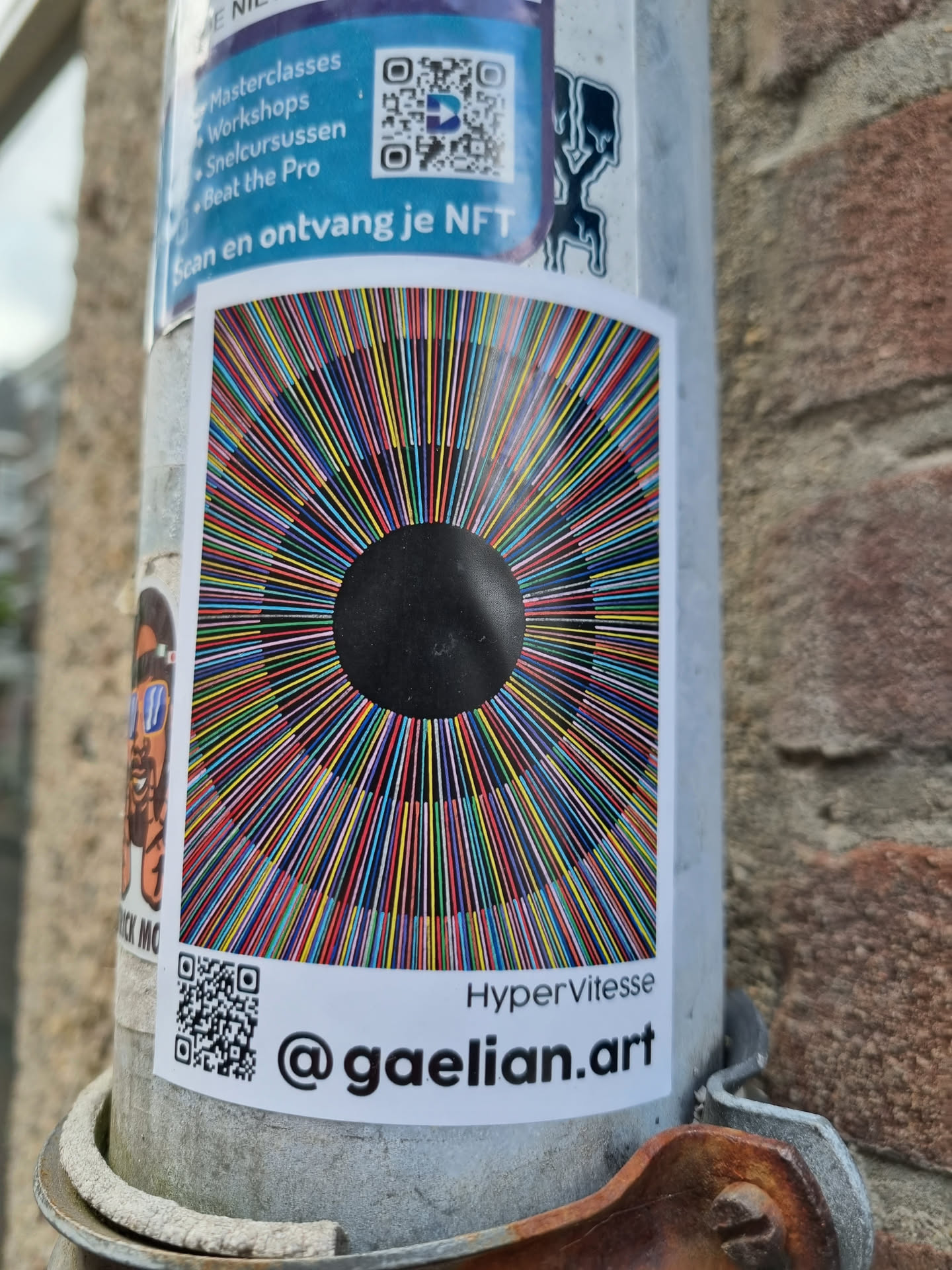 A colorful abstract art sticker with radiating lines converging towards a black center. The sticker includes a QR code and the artist's Instagram handle.