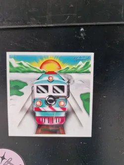 A sticker featuring a stylized illustration of a train approaching the viewer against the backdrop of a sunrise over mountains. The art style is reminiscent of retro or vintage designs.  The train is teal, white, and pink.